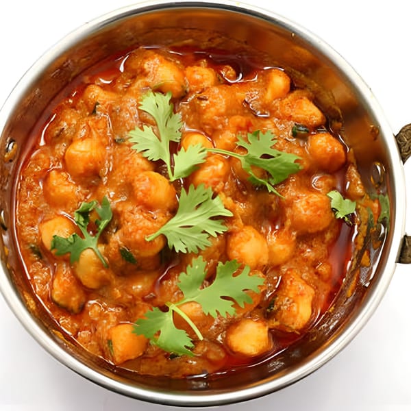 Bawarchi Biryanis' Chana Masala, a chickpea curry garnished with fresh cilantro in a steel bowl.